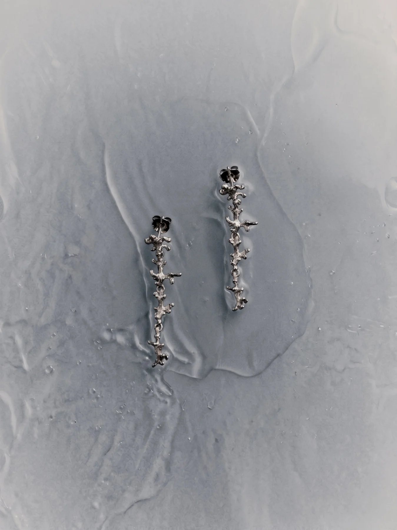 The Algae pendant in sterling silver, textured surface catching light