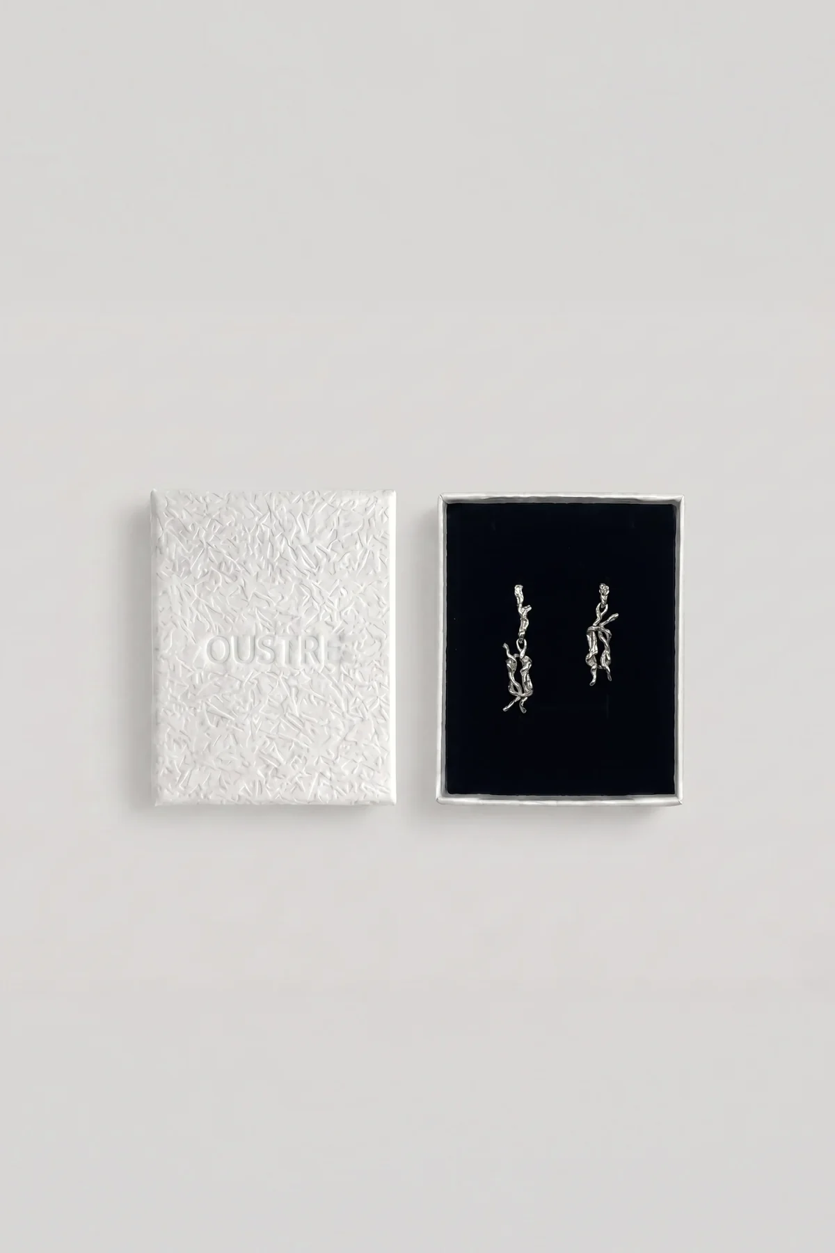 The &knot earrings in their box